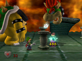 Luigi's Mansion screenshot of the final battle, where Luigi attempts to vacuum King Boo into the Poltergust 3000